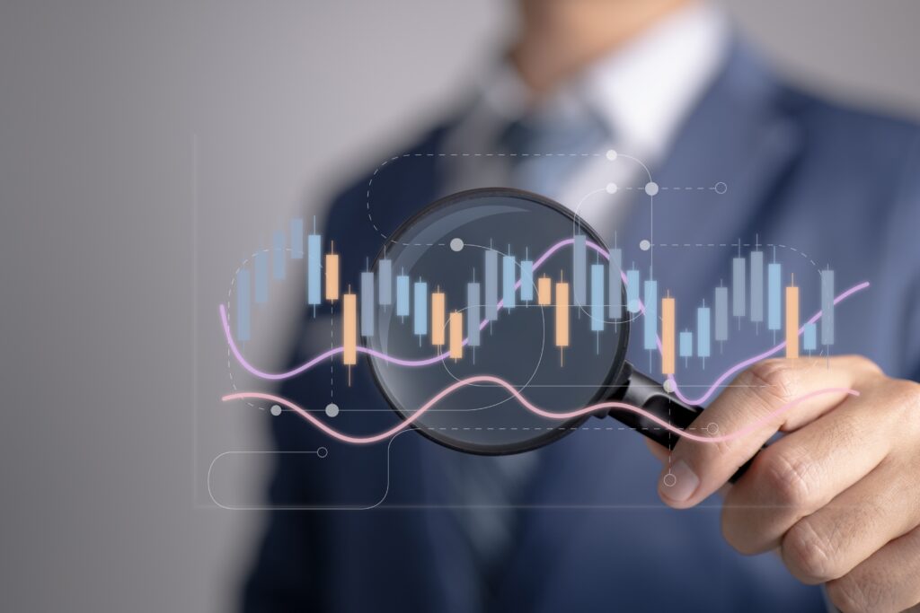 A man looking at statistics with a magnifying glass